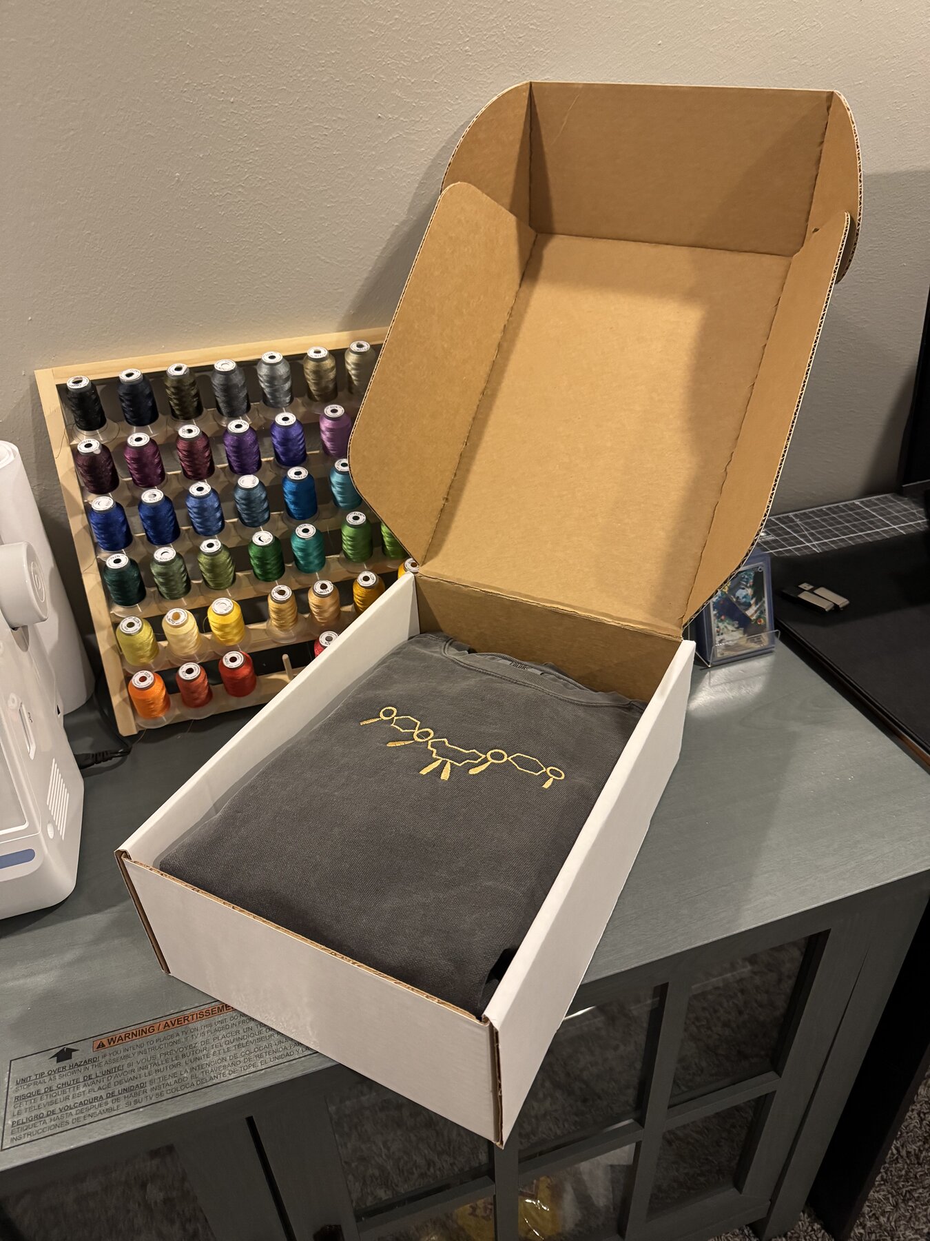 Finished embroidered sweatshirt packaged in a branded box