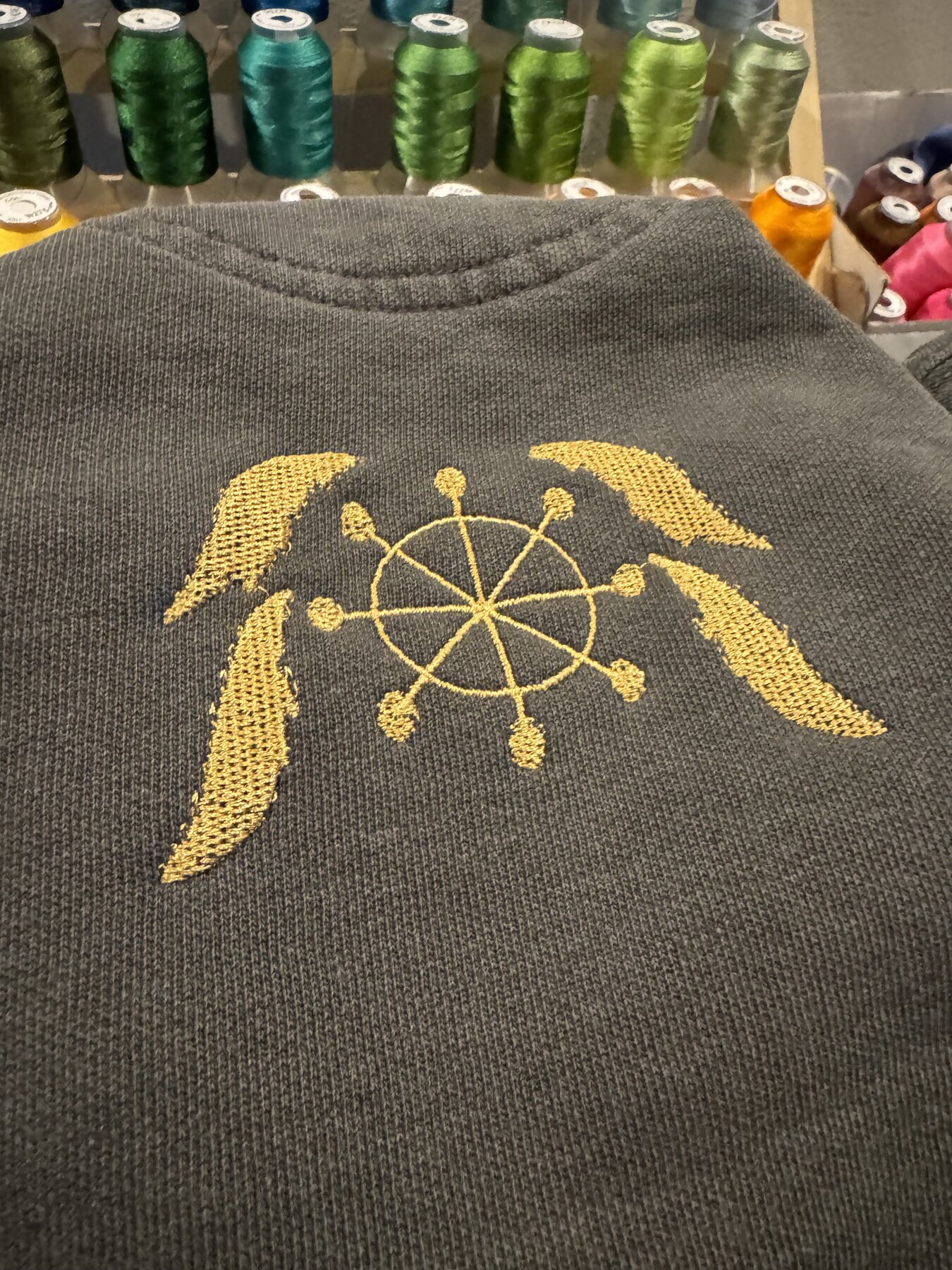 Gold necklace-style embroidery design, close detail